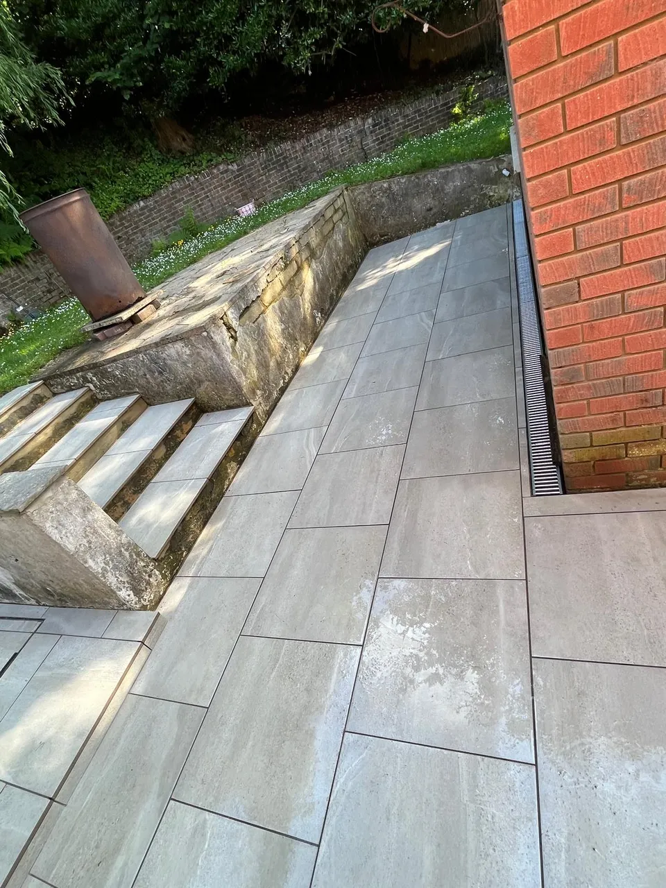 Porcelain paving path beside stone garden steps